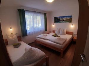 a room with two beds and a window at Haus Pretterhofer in Stummerberg