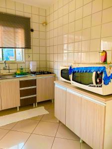 a kitchen with a sink and a counter top at Apto lindo e aconchegante próximo a praia in Itapema