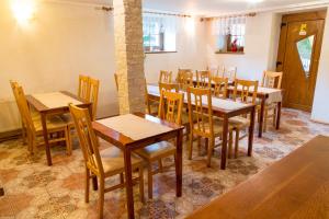 a dining room with wooden tables and chairs at Penzión Teplička in Liptovská Teplička