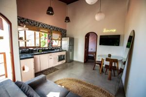 a living room with a couch and a table at Estadia Poética in Pipa