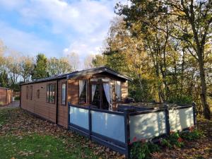 a tiny house is shown in a yard at Biarritz Lodge in Hull