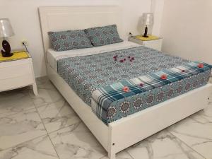 een slaapkamer met een bed met 2 nachtkastjes bij Luxor Best Way in Luxor