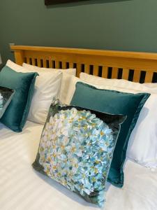 a bed with a pillow with flowers on it at Rufford Arms Hotel in Rufford