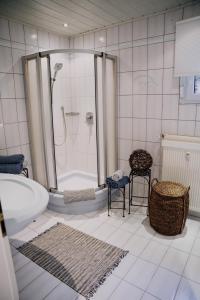 a bathroom with a shower and a bath tub at Waldblick Herborn in Herborn