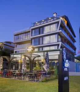 a building with tables and chairs in front of it at Lucky Monkey Hotel in Antalya