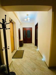 a hallway with two doors and a wooden floor at ОТДЕЛЬНАЯ КВАРТИРА В ЦЕНТРЕ in Makhachkala