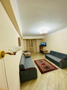 a living room with a couch and a table at ОТДЕЛЬНАЯ КВАРТИРА В ЦЕНТРЕ in Makhachkala
