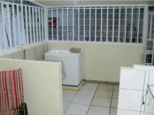 a bathroom with a washer and dryer in a room at Casa Pacífico in Quepos