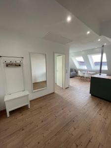 an empty room with white walls and wood floors at Ferienwohnung Balgheim in Balgheim