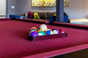 a tray of billiard balls on a pool table at Placemakr Music Row in Nashville