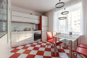 a kitchen with a red and white checkered floor at Apartment Kiev House in Kyiv