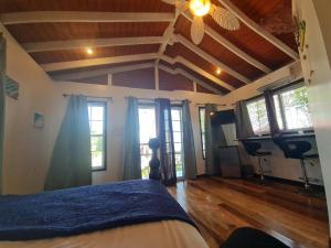 a bedroom with a bed in a room with windows at Seaside Chateau Resort in Belize City