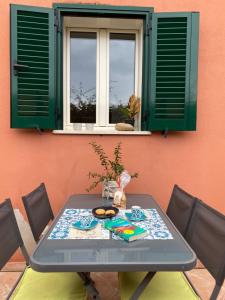 mesa y sillas con mesa y ventana en Appartement Dolce Farniente, en Belgodère