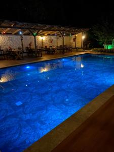 a large swimming pool with blue water at night at Rif Sapanca - Adult Only in Sapanca