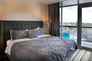 a bedroom with a large bed and a large window at Littlefield Lofts #504 in Austin
