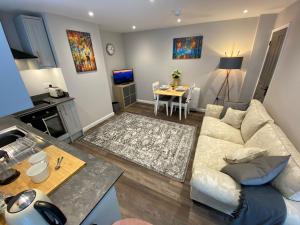 a living room with a couch and a table at Coach House @ The Booth in Hereford +14 photos