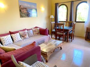 a living room with a couch and a table at Cosy apartment in Corralejo, shared pool, 55 m² in Corralejo