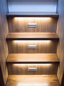 a row of wooden drawers in a closet at Jacht motorowy Nautika 1300 LUX in Wilkasy
