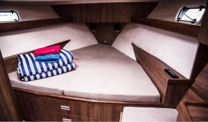a small bed in the back of a boat at Jacht motorowy Nautika 1300 LUX in Wilkasy