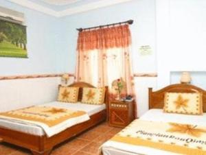 Un ou plusieurs lits dans un hébergement de l'établissement Vinh Huy Hotel