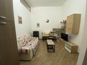 a living room with a couch and a table at La casa di sara in Nuoro