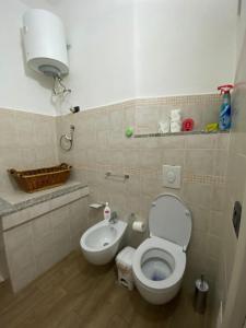 a bathroom with a toilet and a sink at La casa di sara in Nuoro +10 photos