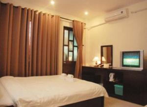 Un ou plusieurs lits dans un hébergement de l'établissement Vinh Huy Hotel