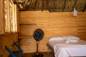 a bedroom with a bed in a wooden room at Isla Múcura Dahlandia in Isla Mucura
