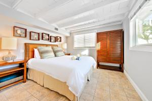 a bedroom with a large bed and a window at Tommy Bahama Beach in Dana Point