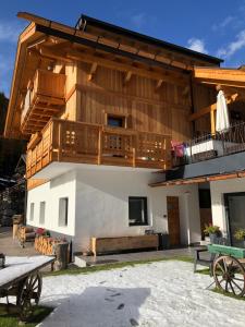 a large building with a balcony and a deck at Cesa Prinoth in Campitello di Fassa