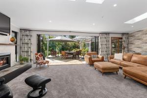 uma sala de estar com um sofá e uma lareira em Westhay Stables - Paparoa Holiday Home em Paparoa
