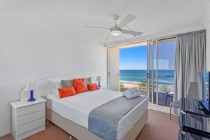 a bedroom with a bed and a view of the ocean at Southern Cross Beachfront Holiday Apartments in Gold Coast