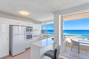 a kitchen with white appliances and a view of the ocean at Southern Cross Beachfront Holiday Apartments in Gold Coast