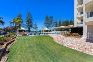a large lawn in front of a building at Southern Cross Beachfront Holiday Apartments in Gold Coast