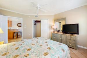 a bedroom with a bed and a flat screen tv at Sea Palms in Ocean City