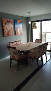 a dining room with a table and two chairs at Praia dos Anjos Residence Clube - O melhor de Arraial do Cabo in Arraial do Cabo