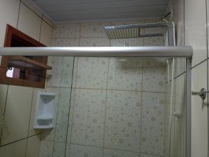 a shower with a glass door in a bathroom at Pousada Bem Estar in Cambara do Sul