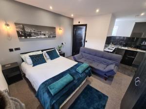 a bedroom with a large bed and a couch at Oxclose studios in Peterborough