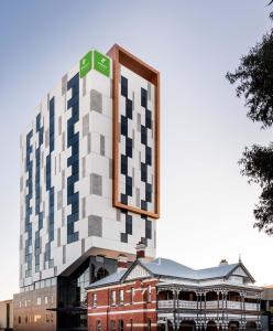 a large building with a clock on the front of it at Holiday Inn West Perth, an IHG Hotel in Perth