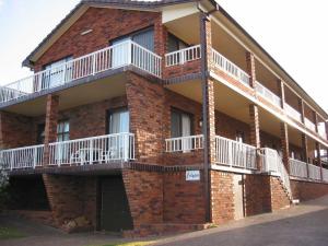 a brick building with balconies on the side of it at Calypso, Unit 1 - The Entrance, NSW in The Entrance