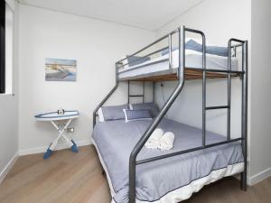 a bedroom with a bunk bed and a desk at Crystal Waters Unit 11 in The Entrance