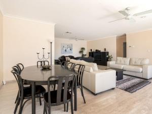 a dining room and living room with a table and a couch at Lakeshore Apartments Unit 5 in The Entrance