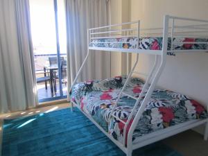 a bedroom with two bunk beds and a balcony at St Tropez Unit 39 in The Entrance