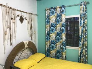 a bedroom with a bed and a window at Soursop Hostel in Cueta