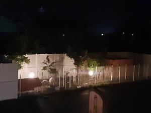 a building with a fence at night with lights at ホテルLambie in Tōgane