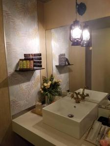a bathroom with a sink and a mirror at ホテルLambie in Tōgane