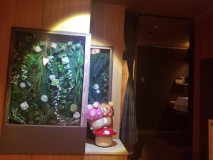 a stuffed animal sitting next to a picture of a garden at ホテルLambie in Tōgane +8 photos