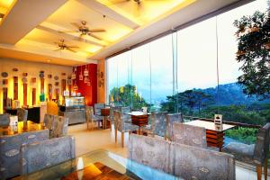 a dining room with a table and chairs and a large window at Chalet Baguio in Baguio