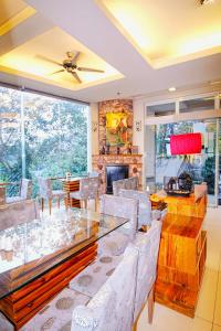 a dining room with a glass table and chairs at Chalet Baguio in Baguio