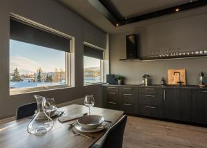a kitchen with a wooden table with wine glasses at AK Rentals, with hot tubs in Akureyri